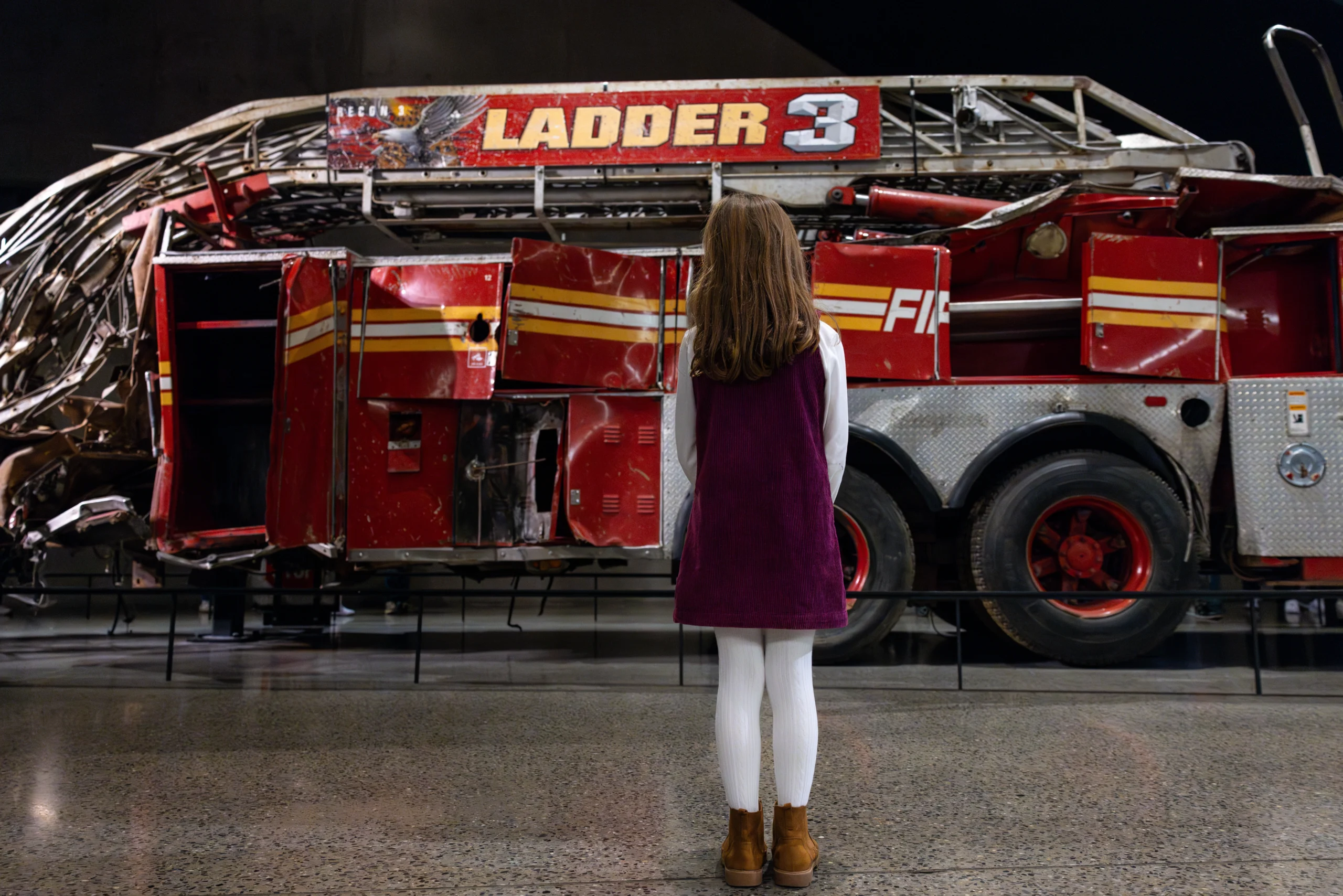 Girl looking at Ladder 3 exhibit in the 9/11 Museum