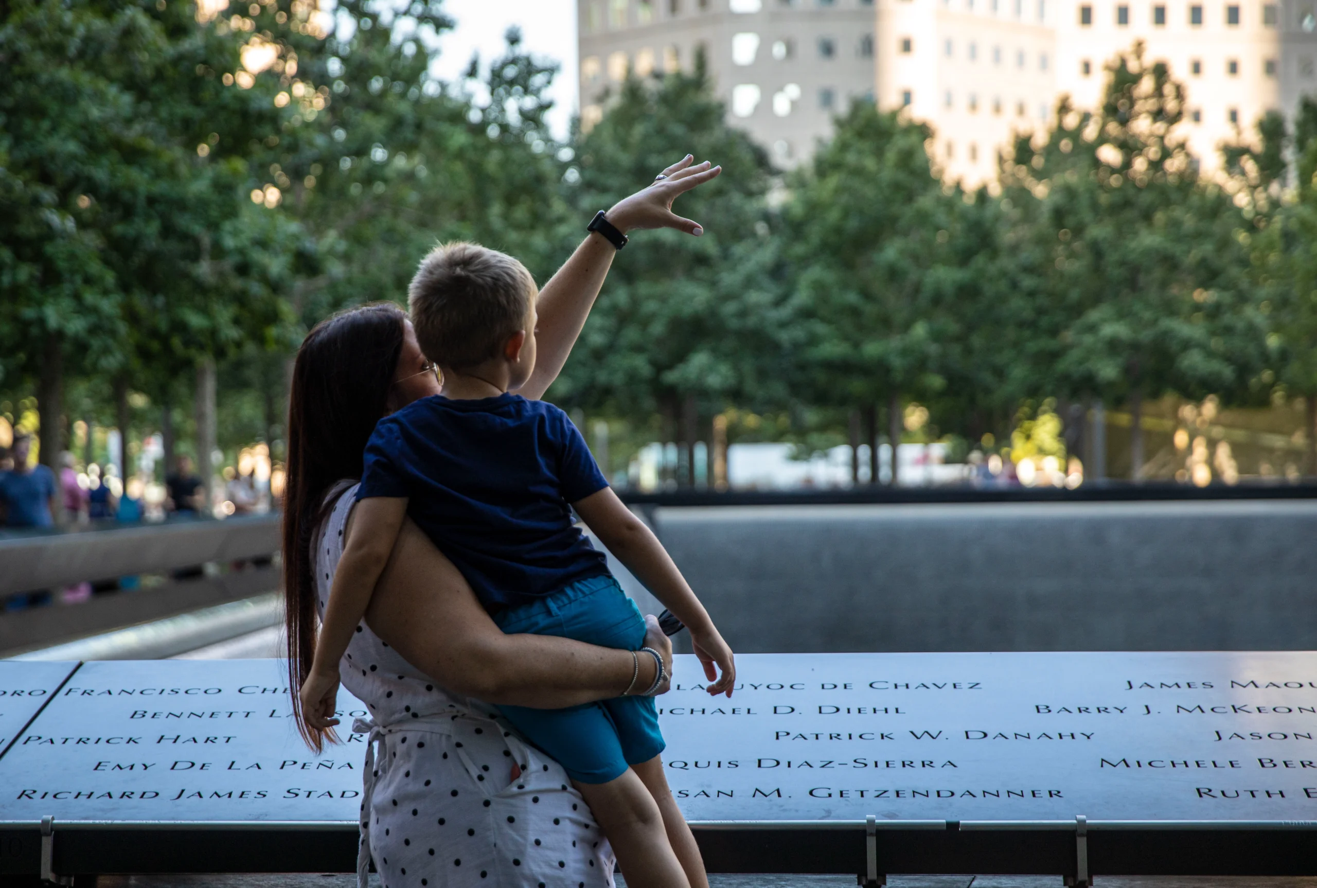 Mother holding child at Ground Zero memorial